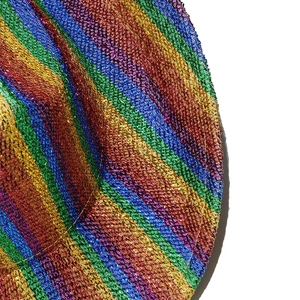 Macro shot of colorful rainbow metallic woven texture on a Western party cowboy hat