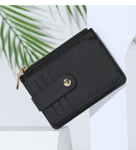 Macro view of black PU leather card holder with multiple slots and golden zipper