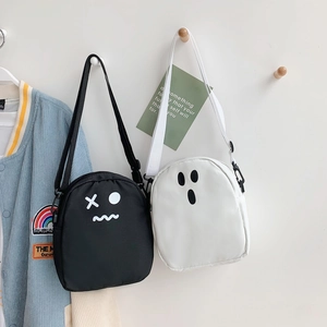 Détail de mini sacs à bandoulière mignons avec expressions amusantes en noir et blanc