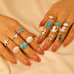 Marine life ocean rings collection featuring seahorse and shell with colorful oil drip finish