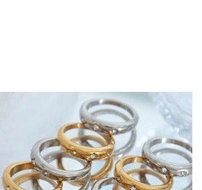 Macro shot of gold and silver plated heart rings with inlaid cat's eye stones