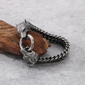 Detailed view of vintage wolf head steel bracelet wrapped on weathered wood background