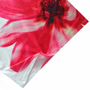 Detailed close-up of double-stitched hem on a floral print polyester mini dress