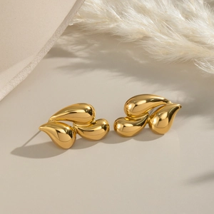 Elegant 18K gold plated stainless steel teardrop earrings on a minimalist stone display