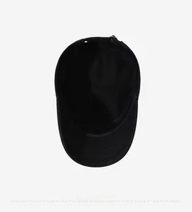 Detail view of the black cotton flat top cap showing inner seams and metal buckle strap