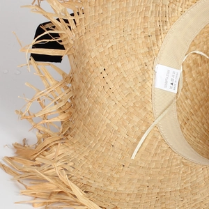 Detail of 100% natural raffia straw weave and sweatband on French sun hat