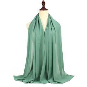 Classic green solid pearl chiffon hijab long scarf wrap shown on mannequin in studio