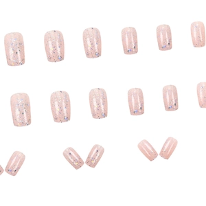 Sparkling pale pink press-on nails with iridescent glitter and a mirror powder finish