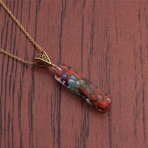 Collier pendentif aurore en résine et pierre fait main avec chaîne dorée sur bois
