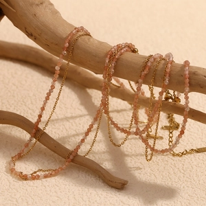 Double-layered 18K gold plated necklace with sunstone beads on a natural wooden branch