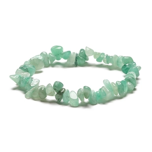 Macro shot of irregular light green natural stone beads on a handmade beaded bracelet