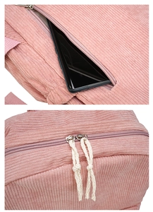 Detail of pink corduroy backpack featuring a side hidden pocket and double zipper closure