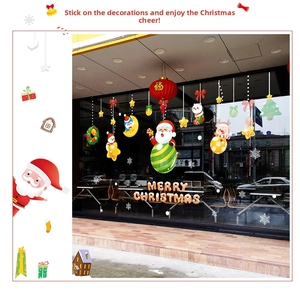 Detail of Christmas window clings showing Santa, reindeer, and snowflakes on a glass storefront