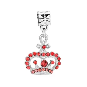 Macro view of silver crown charm with sparkling red crystals for DIY charm bracelets