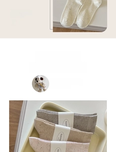 Detail of vintage knit socks with flecked texture and wide ribbed cuffs in neutral tones