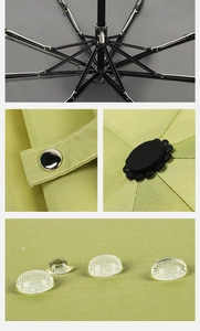 Detail view of reinforced black metal umbrella frame and floral daisy top decoration