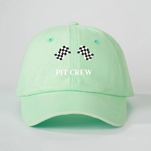 Detail of mint green cotton baseball cap with crossed racing flags and PIT CREW print
