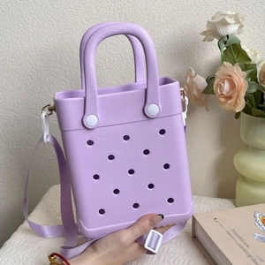 Detailed close-up of a purple EVA hollow-out tote bag with a matching handle and strap