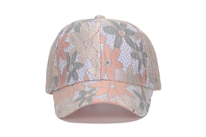 Close-up of intricate mesh lace texture and colorful floral embroidery on baseball cap