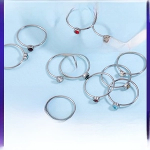 Set of minimalist stainless steel stud earrings featuring colorful CZ birthstones