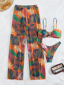 Detailed flat lay of three-piece tropical print bikini set with sheer mesh wide-leg pants