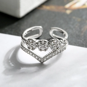 Macro detail of gold-plated geometric rings set featuring zircon flowers and V-shape band