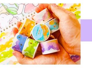 Close-up of Cloud Dreamworld washi tape with gold stars held in hands for journaling