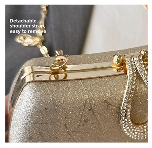 Detail of glitter evening bag with rhinestone V-decoration and detachable gold chain