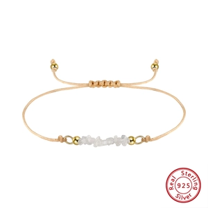 Detail of 925 sterling silver beaded bracelet with natural white stones and woven cord