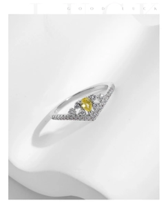 Detailed view of s925 silver crown ring with a yellow pear-cut gemstone and pave zircons