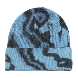 Detailed close-up of blue and black tie-dye ribbed knit beanie with a folded cuff
