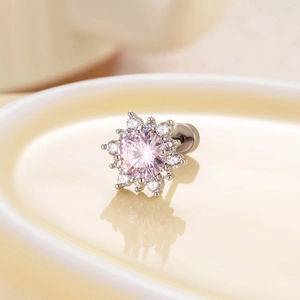 Titanium steel snowflake stud earrings with pink zircon and clear crystals on ceramic plate
