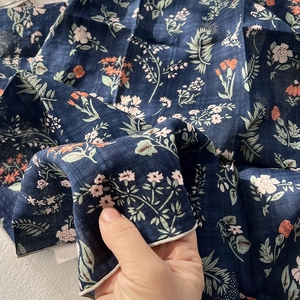 Close-up of navy blue floral cotton-linen scarf with intricate pink and orange prints