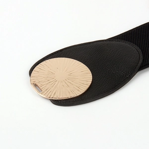 Elastic black waist belt with a golden sunburst round buckle and faux leather detail
