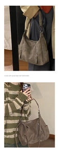 Detail view of large dark taupe faux suede hobo bag with zip accents and side pockets