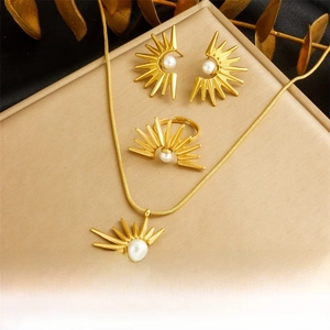 Detailed set of gold sunflower jewelry with white pearls on a luxury display box