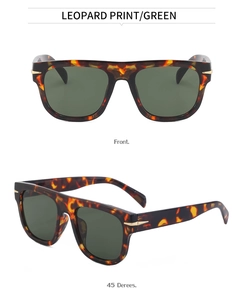 Detail of tortoise frame sunglasses with golden arrow accents and green lenses