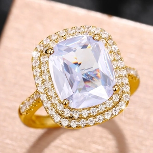 Macro shot of cushion cut gemstone ring with gold plating and luxury halo diamond setting