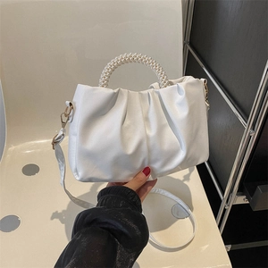 White ruched faux leather handbag featuring elegant pearl handle and crossbody strap