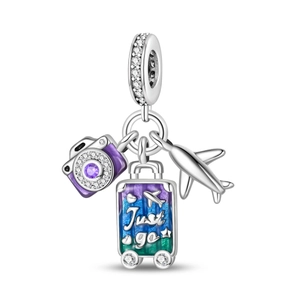 Detail of travel charms featuring a purple camera, airplane, and Just Go suitcase
