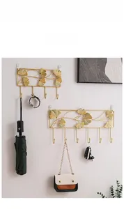 Golden ginkgo leaf iron wall hooks showing multiple hooks with home accessories