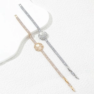 Elegant gold and silver link bracelets featuring rectangular cut zircons and a circular motif