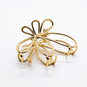Elegant gold flower hollow metal hair claw clip with a glossy finish for women's updos