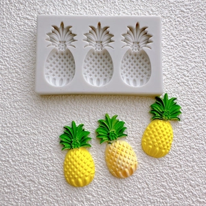 Macro view of pineapple-shaped silicone mold and textured yellow fruit replicas