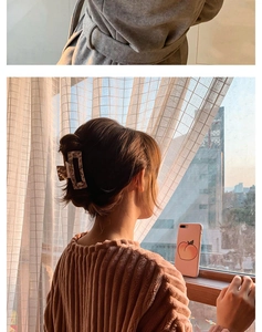 Large tortoiseshell hair claw clip shown in use on thick hair for elegant styling