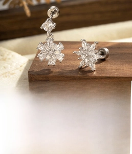 Macro detail of silver snowflake ear stud with zircon micro-inlay and titanium steel screw post
