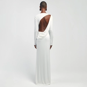 Detailed view of backless cutout design on a sleek white long-sleeve maxi dress