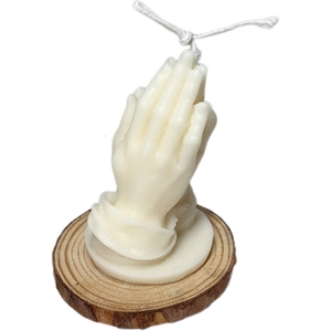 Prayer hands scented candle on a rustic wood base for zen home decoration