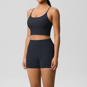 Detail of black two-piece yoga set with thin straps sports bra and high-waisted shorts
