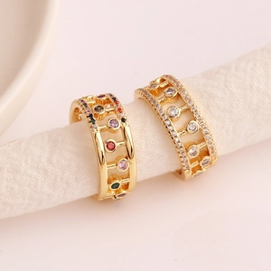 Macro shot of gold-plated hollow geometric ring with colorful cubic zirconia stones